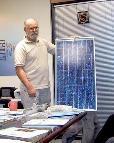 Person holding a sparkly solar panel.